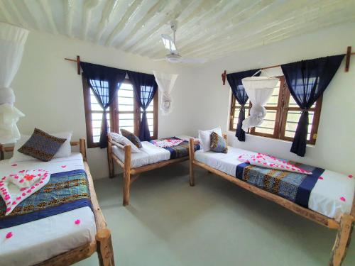 Postel nebo postele na pokoji v ubytování Blue Palm Zanzibar