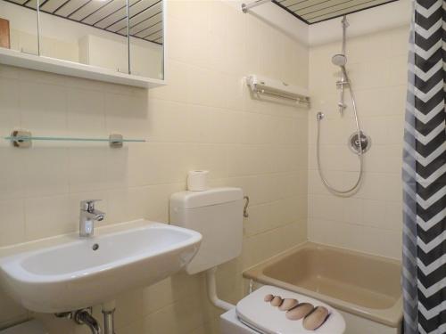 a bathroom with a sink and a toilet and a shower at Strandhausvilla 9 in Dahme