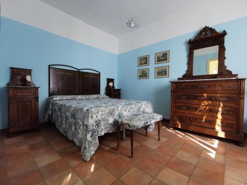 a bedroom with a bed and a dresser and a mirror at Ca' le Suore in Cagli