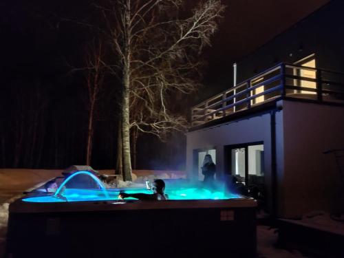 a man is standing in a backyard at night at Sonda puhkemaja in Sonda