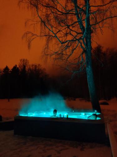 a hot tub in the snow at night at Sonda puhkemaja in Sonda