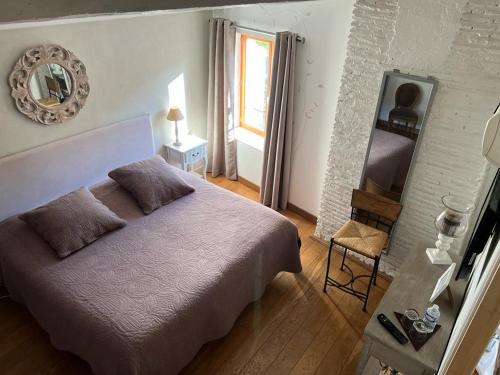 מיטה או מיטות בחדר ב-Chambres d'Hôtes Mado et Lulu