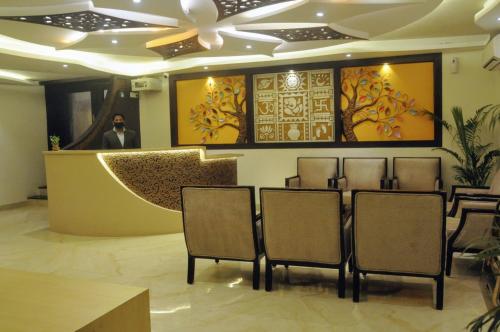 a row of chairs in a room with a ceiling at Hotel City Walk in Bhopal