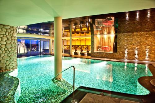 a large swimming pool in a building at Głęboczek Vine Resort& Spa in Wielki Głęboczek