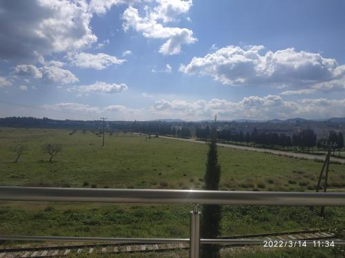 a view of a field from a highway at STUDIOS POSEIDONIA apartments 50 & 70 sqm with sea view in Korinthos