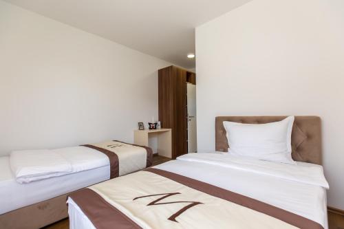 Postel nebo postele na pokoji v ubytování Malak Resort Sarajevo