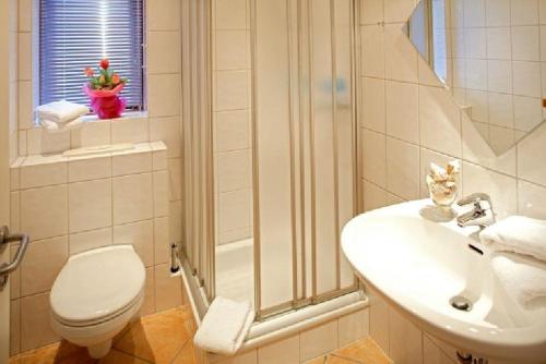 a bathroom with a shower and a toilet and a sink at Theodor Heuss in Westerland