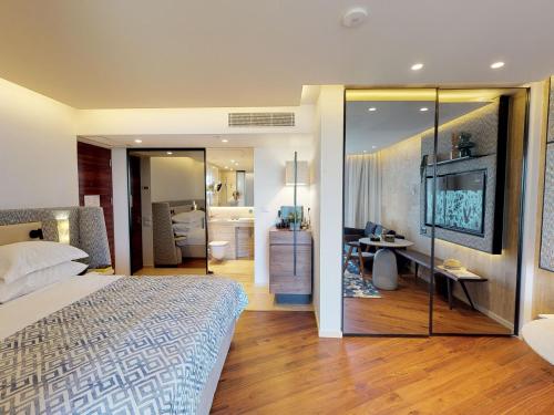 a bedroom with a bed and a television in it at Dan Caesarea Resort in Caesarea