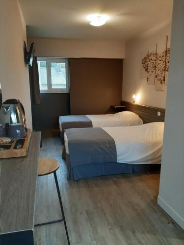 Ένα ή περισσότερα κρεβάτια σε δωμάτιο στο Hostellerie de la Poterne