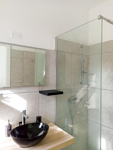 a bathroom with a sink and a glass shower at Kolossoi Guest House in Càbras