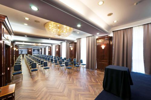 a large room with a lot of tables and chairs at Radisson Blu GHR Rome in Rome