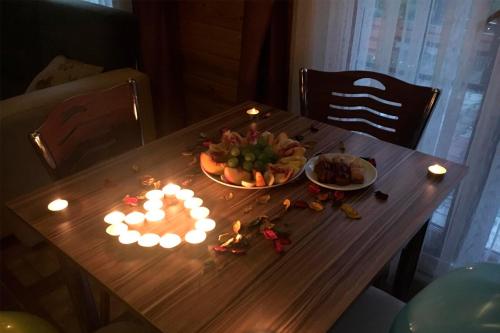 a table with a plate of food and lights on it at Çakıroğlu Villa Kent in Uzungol