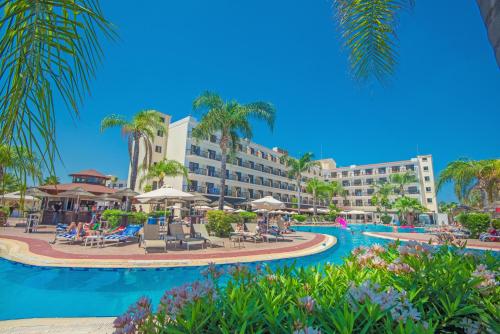 a resort with a swimming pool and a resort at Tsokkos Gardens Hotel in Protaras