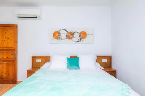 a bedroom with a large bed with a blue comforter at S'Hort Can Capità in Ariany