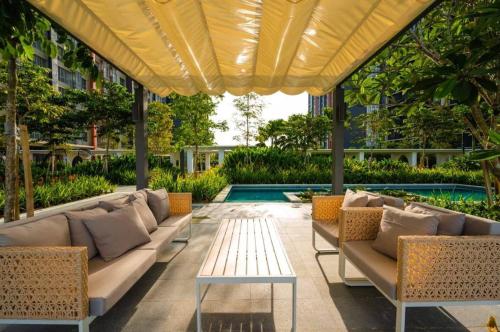 a patio with couches and a table and a pool at Wallaway2stay Gravit8 Klang 2Room in Klang