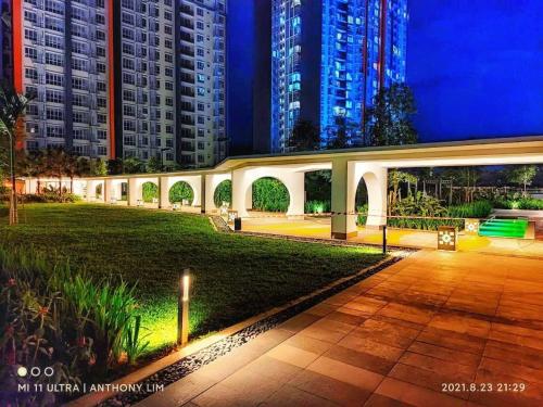 a walkway in a park at night with tall buildings at Wallaway2stay Gravit8 Klang 2Room in Klang