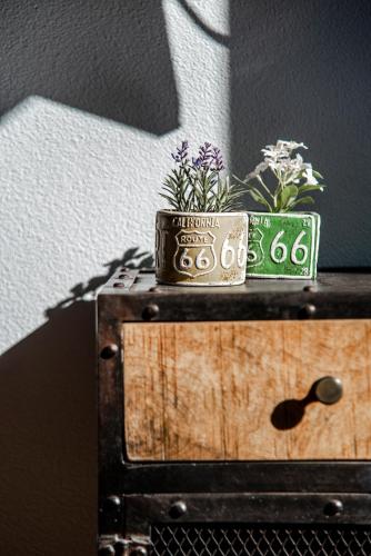 a small pot of flowers on top of a wooden box at Pension Sixtysix in Zandvoort