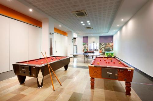 two billiard tables in a room with ahibition at Eurostars Las Salinas in Caleta De Fuste