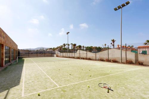 a tennis court with a tennis racket on it at Eurostars Las Salinas in Caleta De Fuste