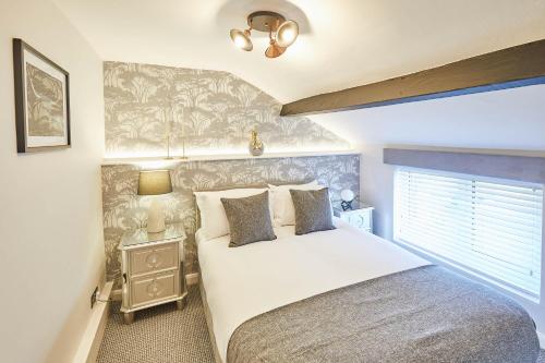 a bedroom with a large white bed with a window at Host & Stay - 19 West End in Hurworth