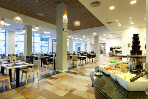 a restaurant with tables and chairs and a buffet at Eurostars Las Salinas in Caleta De Fuste