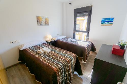 A bed or beds in a room at RentalSevilla Virgen de Loreto