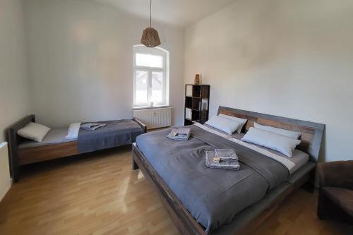a bedroom with two beds and a couch and a window at Haus Felsenpost in Stadt Wehlen