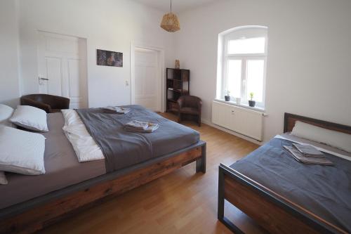 a bedroom with two beds and a window at Haus Felsenpost in Stadt Wehlen