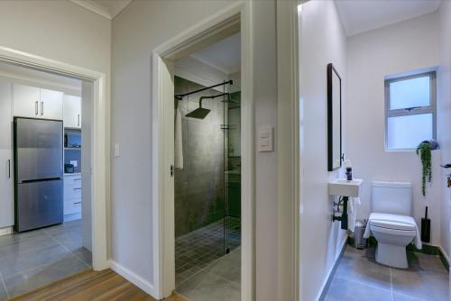 a bathroom with a shower and a toilet and a sink at Harvil House in George