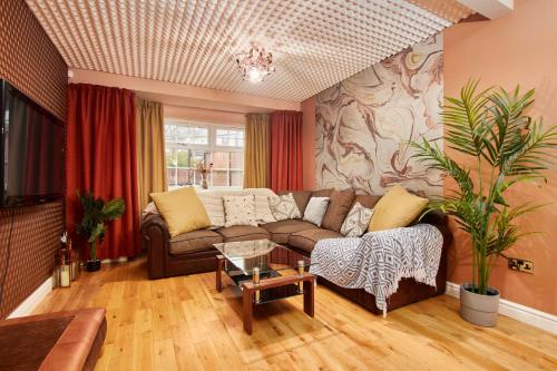 a living room with a couch and a table at Homebird Property - Carter Knowle House in Sheffield