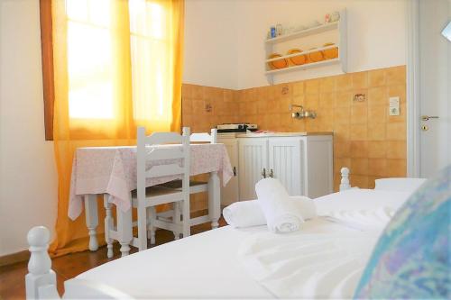 a room with two beds and a table and chairs at Jasmine apartments in Pythagoreio