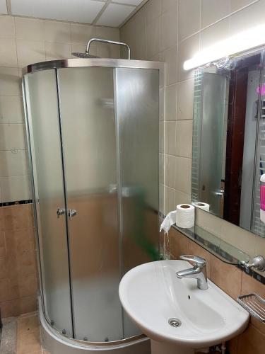 a bathroom with a shower and a sink at AlBarsha 1 Hostel by PHM in Dubai