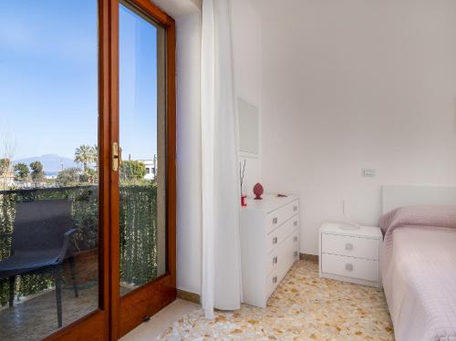 um quarto com uma cama e uma porta de vidro deslizante em ENEA apartment in Sorrento center em Sorrento