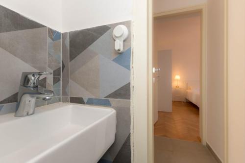a bathroom with a sink and a bathroom with a bedroom at Apartment Tana in Pula