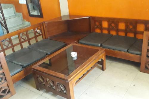 a couch and a coffee table in a room at Oma Homestay Pagar Alam Syariah RedPartner in Pagaralam