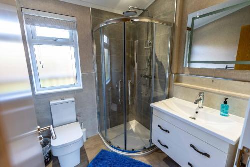 モルトンにあるDeneb Lodge with Hot Tubのシャワー、トイレ、洗面台を備えたバスルーム