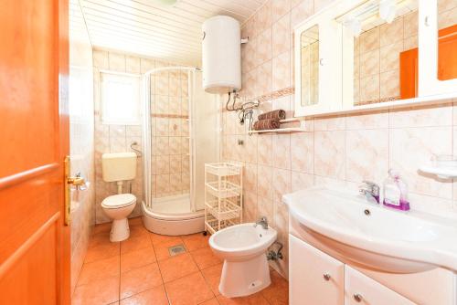 a bathroom with a toilet and a sink at Apartment Kelly in Novalja