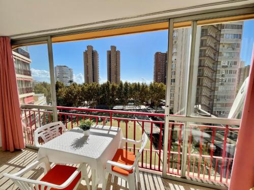 a balcony with a table and chairs and a view of a city at La Oca - Aloturin Benidorm in Benidorm