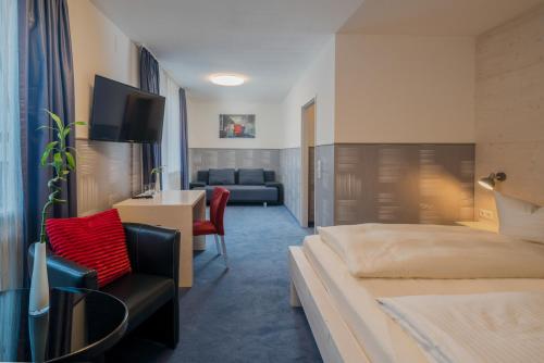 a hotel room with a bed and a couch at Hotel Fidelio in Munich