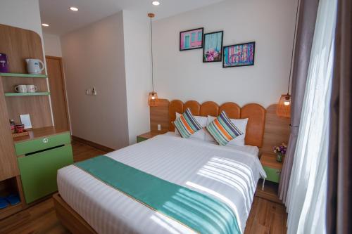 a bedroom with a large bed in a room at The View Hotel in Cam Lâm