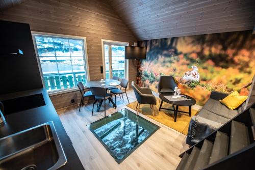 an overhead view of a living room with a table and chairs at Manndalen Sjøbuer in Samuelsberg