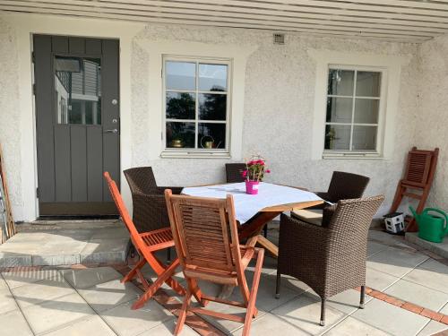 a wooden table and chairs on a patio at Pärla med egen brygga in Västerås