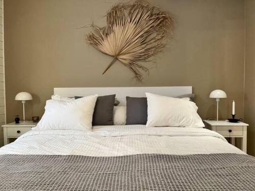 a bedroom with a large bed with white pillows at The Novac's Cottage in Råneå