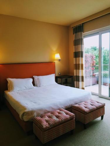 a bedroom with a large bed and a large window at Villa Maria Hotel & SPA in Francavilla al Mare