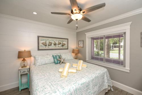 a bedroom with a large bed and a large window at Tropical Breeze Resort in Sarasota