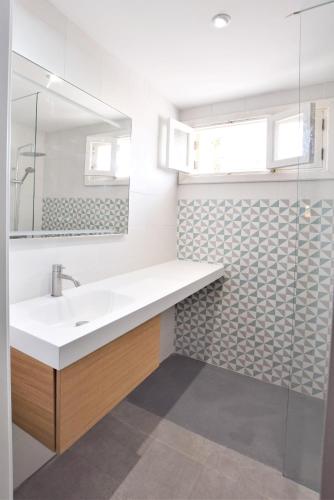 a bathroom with a sink and a mirror at Xarus 1 in Alcudia