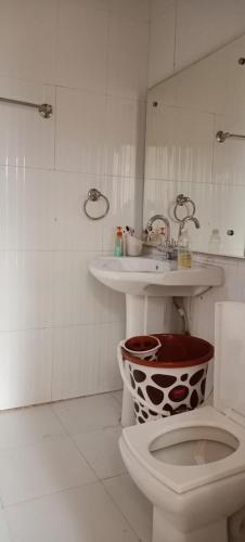 a bathroom with a toilet and a sink at Shiv Gauri Home Stay in Rishīkesh