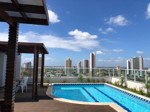 a swimming pool on the roof of a building at Studio Comfort West Flat in Mossoró