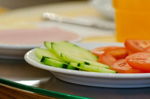 a white bowl of vegetables on a table at Hotel Duas Nações in Lisbon