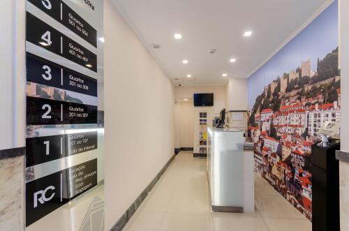 a store aisle with signs on the wall at Hotel Duas Nações in Lisbon
